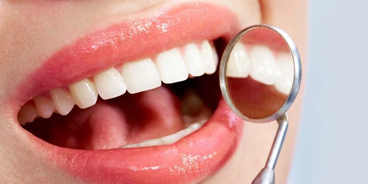 Image of beautiful mouth with health teeth and mirror
