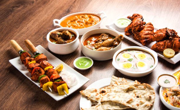 Assorted Indian Non Vegetarian food recipe served in a group. Includes Chicken Curry, Mutton Masala, Anda/egg curry, Butter chicken, biryani, tandoori murg, chicken-tikka and naan/roti