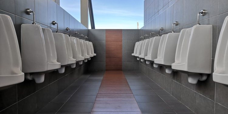 Pattern of urinals for men on background,ceramic urinals in a row in men public restroom. Urine infections.male toilet.