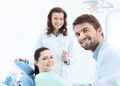 Dentist, his assistant and the patient are preparing to treat carious teeth