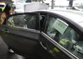 FILE - In this March 15, 2017, file photo,  a passenger enters an Uber car at LaGuardia Airport in New York. Taxi regulators on Tuesday, Dec. 4, 2018, in New York City, approved new minimum pay standards for app-based car services that they say will raise drivers' annual earnings by $10,000 a year. (AP Photo/Seth Wenig, File)