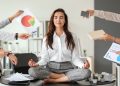 Businesswoman with a lot of work to do meditating in office